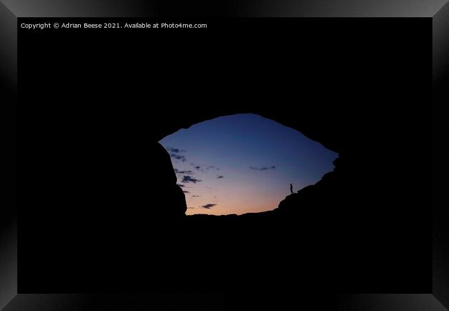 Sunrise through the North Window Arch Framed Print by Adrian Beese