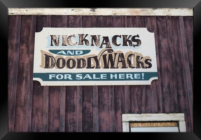 A faded tin sign on a wooden wall in Wyoming Framed Print by Adrian Beese