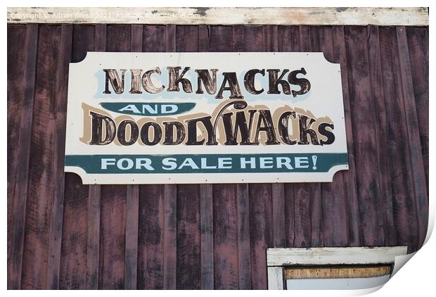 A faded tin sign on a wooden wall in Wyoming Print by Adrian Beese