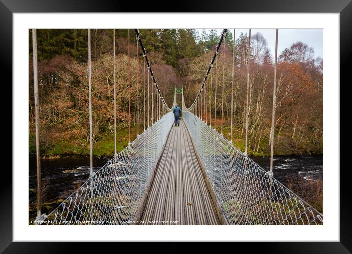 Man walking over an old wooden suspension bridge across a river in Scotland Framed Mounted Print by SnapT Photography