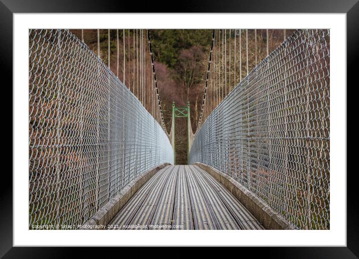 View across a wooden suspension bridge leading into a forest woodland Framed Mounted Print by SnapT Photography