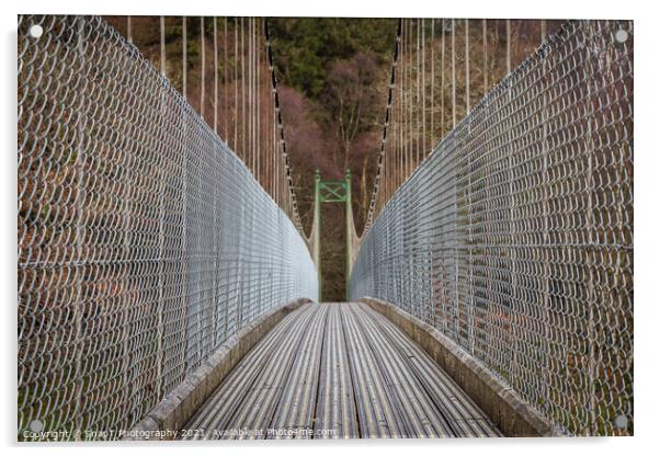 View across a wooden suspension bridge leading into a forest woodland Acrylic by SnapT Photography