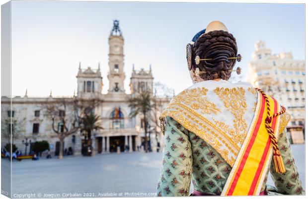 Woman dressed as a Fallera with her back turned, observes the facade of the Valencia City Hall, out of focus in the background. Canvas Print by Joaquin Corbalan