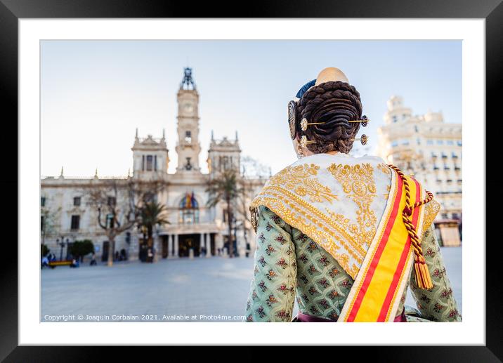 Woman dressed as a Fallera with her back turned, observes the facade of the Valencia City Hall, out of focus in the background. Framed Mounted Print by Joaquin Corbalan