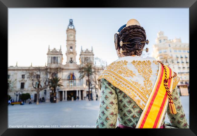 Woman dressed as a Fallera with her back turned, observes the facade of the Valencia City Hall, out of focus in the background. Framed Print by Joaquin Corbalan