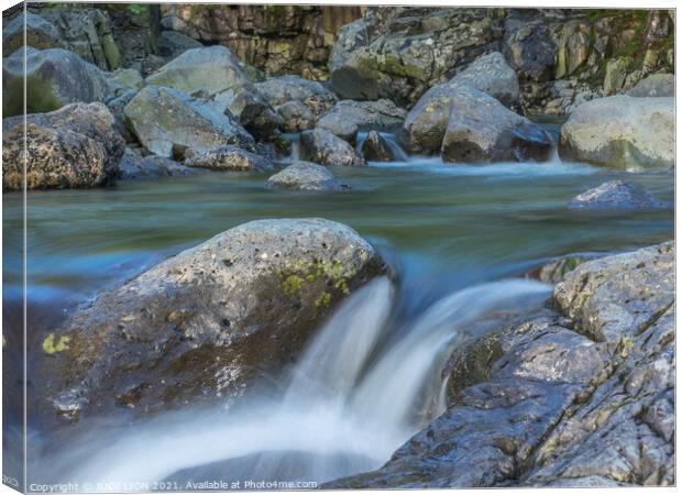 Water flowing over rocks Canvas Print by JUDI LION