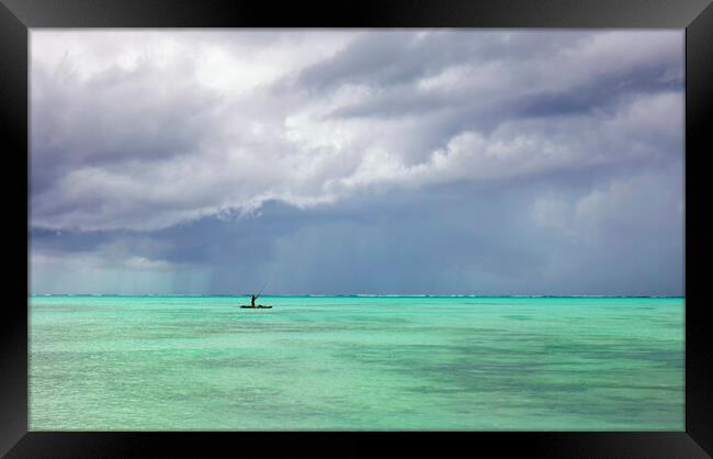 Storm Clouds gather over a boat, Zanzibar Framed Print by Neil Overy