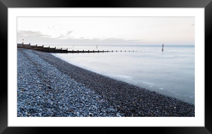 Groynes stretch out from the pebbly beach at Sheringham Framed Mounted Print by Jason Wells