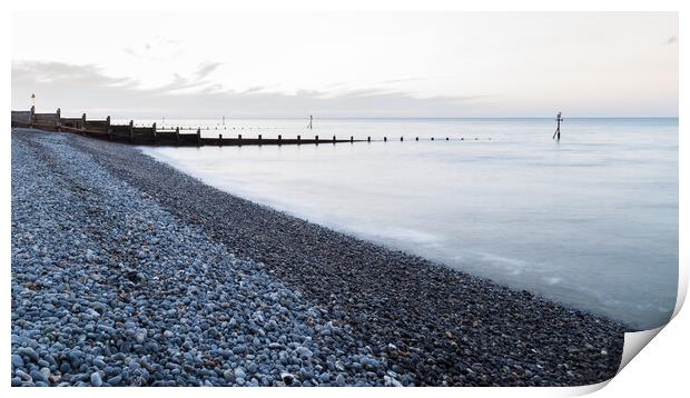 Groynes stretch out from the pebbly beach at Sheringham Print by Jason Wells