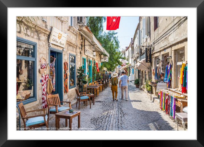 Couple walking down a narrow street Framed Mounted Print by Kevin Hellon