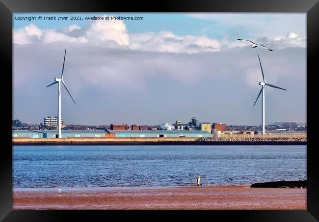 A lone fisherman dwarfed by two "on-shore wind tur Framed Print by Frank Irwin