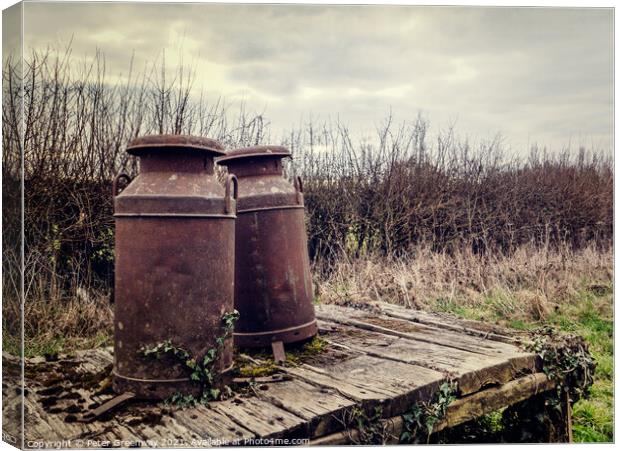 Rusted Vintage Milk Churns On A Wooden Platform Canvas Print by Peter Greenway