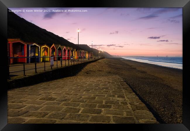 Beach Huts at sunset Framed Print by Kevin Winter