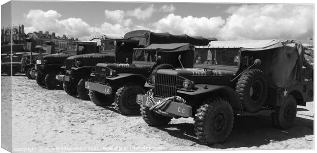 Military trucks and jeeps on Weymouth beach in mon Canvas Print by Ann Biddlecombe