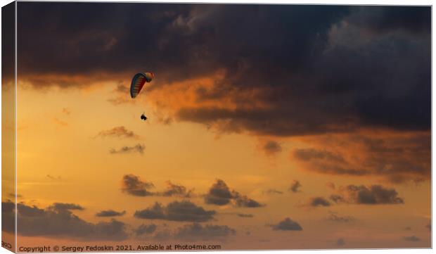 Paraglider flying in the beautiful sky against the background of Canvas Print by Sergey Fedoskin
