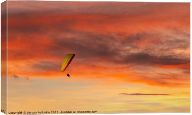 Paraglider flying in the beautiful sky against the background of Canvas Print by Sergey Fedoskin