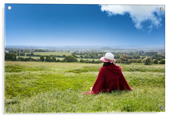 Woman sitting down in grassy farm fields while looking at the ho Acrylic by Thomas Baker