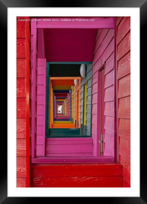 Through the beach huts Framed Mounted Print by Kevin Winter