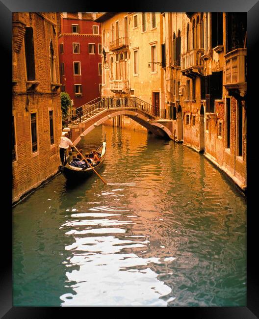 Gondola with tourist on backwater Framed Print by Philip Enticknap