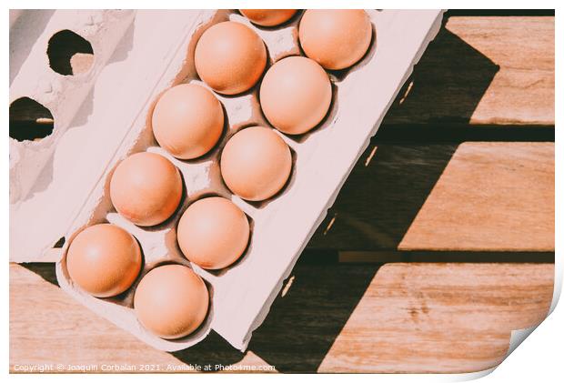 Recycled cardboard box with fresh eggs, viewed from above. Print by Joaquin Corbalan
