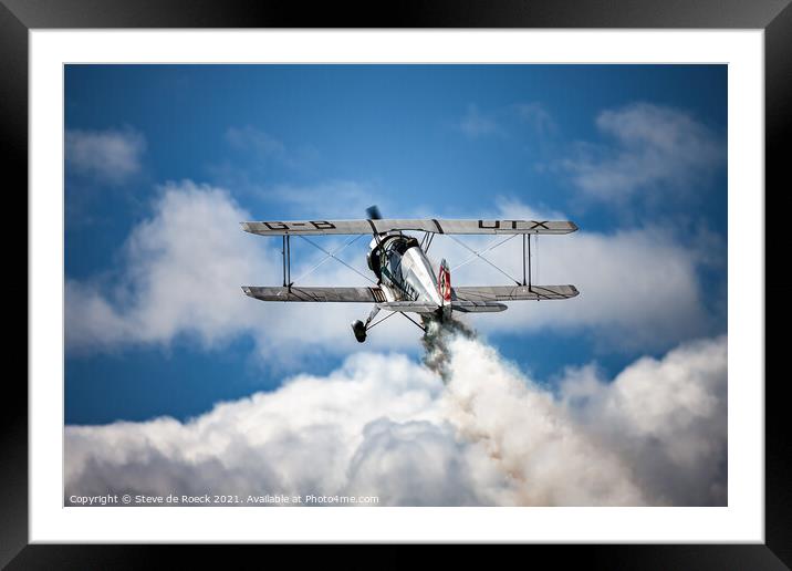 Old Biplane pulls up over the clouds Framed Mounted Print by Steve de Roeck