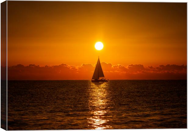 A lone sailboat sailing in the dawn sun Canvas Print by Vicen Photo