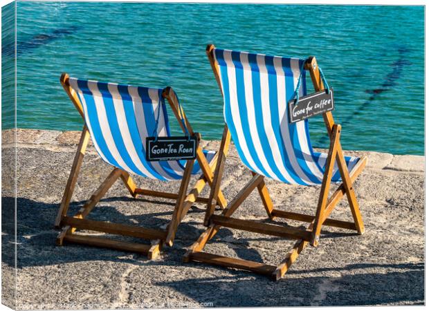 A pair of blue striped deckchairs with reserved signs, St. Ives harbour, Cornwall Canvas Print by Photimageon UK