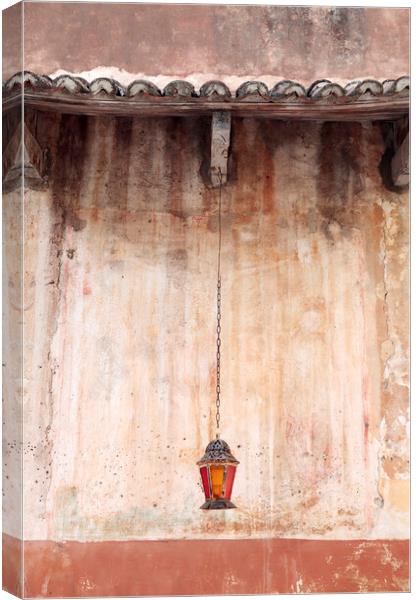 An old lantern hangs against a wall, Corfu, Greece Canvas Print by Neil Overy