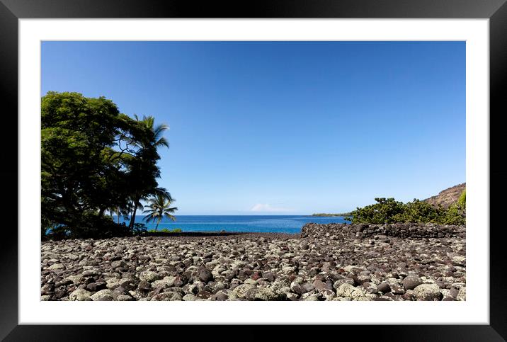 Front view of a rock beach in Hawaii with ocean and sky in backg Framed Mounted Print by Thomas Baker