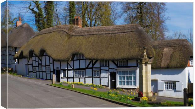 Thatched Cottage and War Memorial Wherwell,Hampshire ,England. Canvas Print by Philip Enticknap