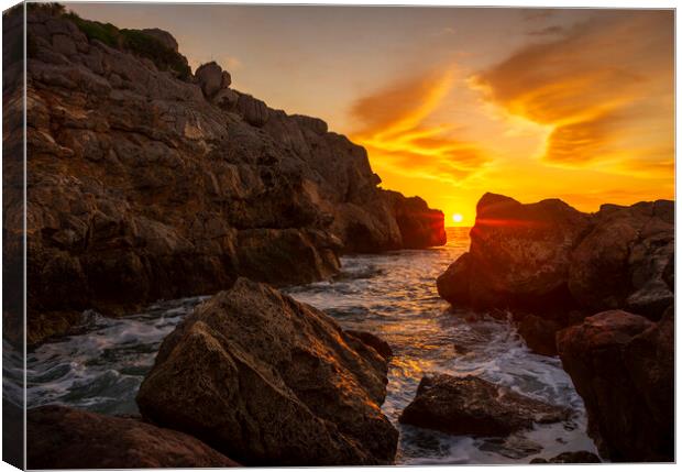 A sunrise between the rocks in a cove in La Renega, Oropesa Canvas Print by Vicen Photo