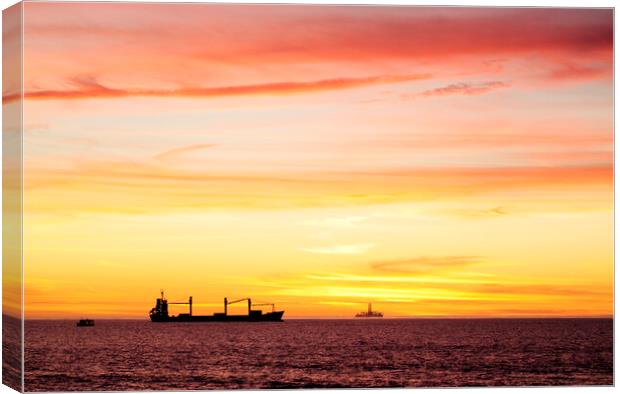 Sunset over ships waiting to enter Cape Town Harbour, South Africa Canvas Print by Neil Overy