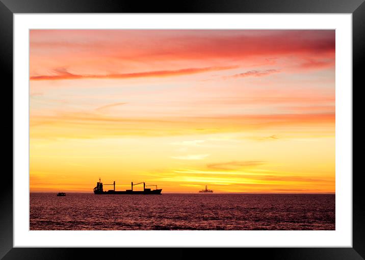 Sunset over ships waiting to enter Cape Town Harbour, South Africa Framed Mounted Print by Neil Overy