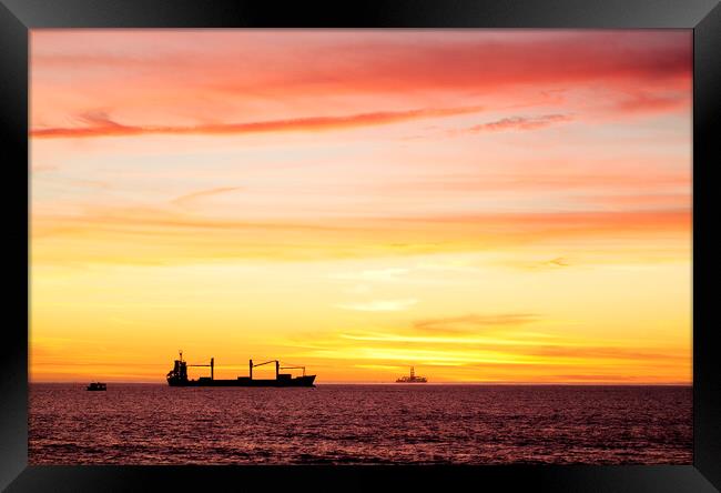Sunset over ships waiting to enter Cape Town Harbour, South Africa Framed Print by Neil Overy