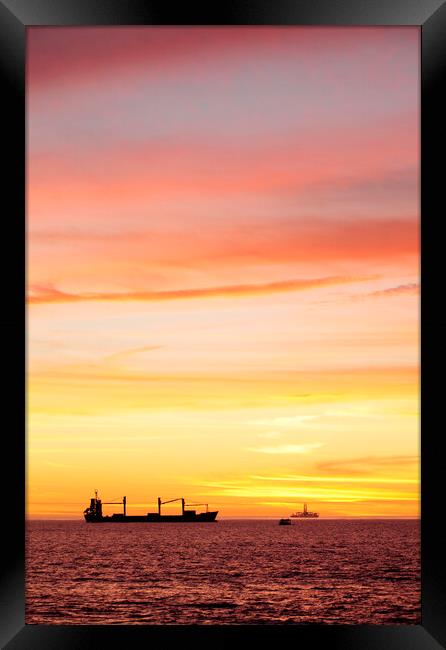 Sunset over ships waiting to enter Cape Town Harbour Framed Print by Neil Overy