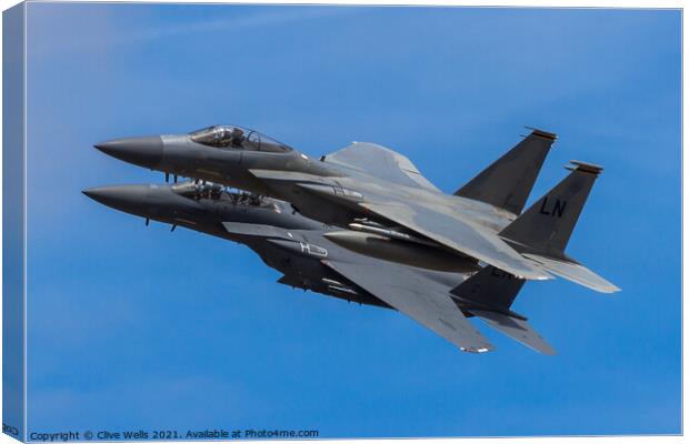 A pair of F-15 Eagles overfly Canvas Print by Clive Wells