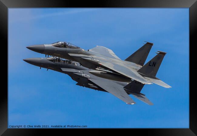 A pair of F-15 Eagles overfly Framed Print by Clive Wells