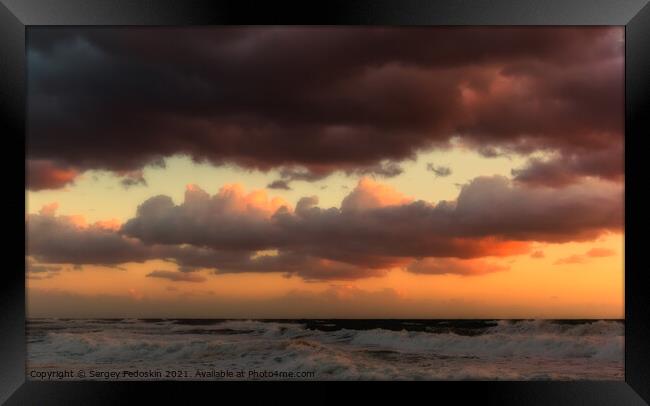Cloudy sunset at the stormy sea. Framed Print by Sergey Fedoskin