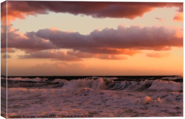 Cloudy sunset at the stormy sea. Canvas Print by Sergey Fedoskin
