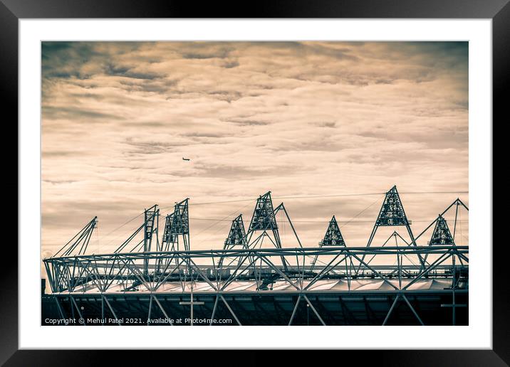 Airplane flying over the 2012 Olympic Stadium in Stratford, London, England, UK Framed Mounted Print by Mehul Patel