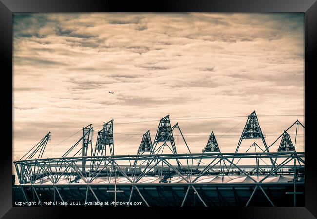 Airplane flying over the 2012 Olympic Stadium in Stratford, London, England, UK Framed Print by Mehul Patel