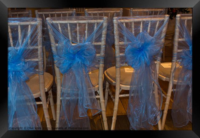 Chairs with blue ribbons Framed Print by Clive Wells