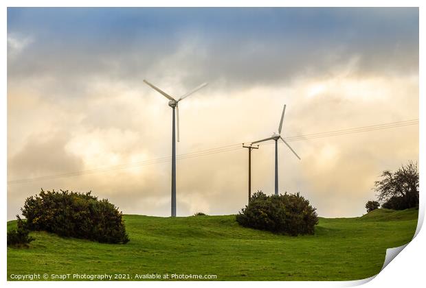 Wind turbines in a green field on the horizon on a cloudy day at sunset Print by SnapT Photography