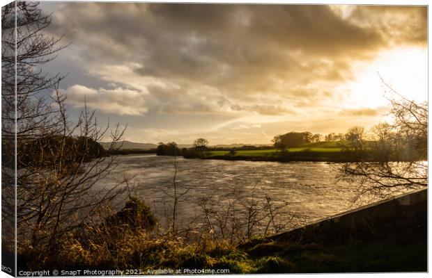 Sun setting over the River Dee at Glenlochar Bridge, on a winter afternoon Canvas Print by SnapT Photography