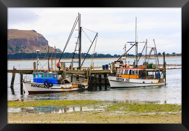  Fishing boats moored at a pier Framed Print by Kevin Hellon