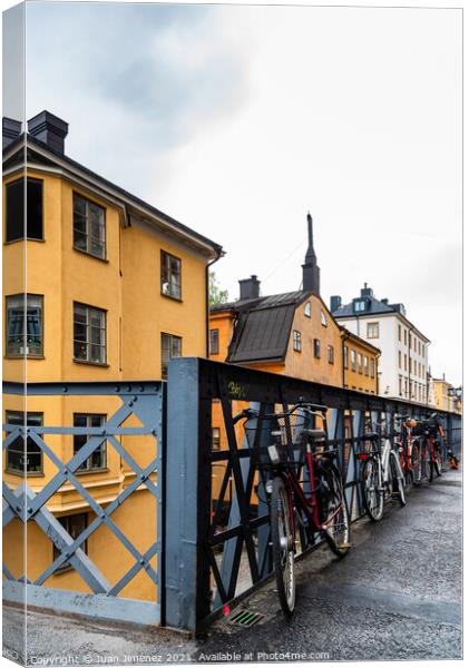 Bicycles parked in the street with colorful houses in Sodermalm  Canvas Print by Juan Jimenez