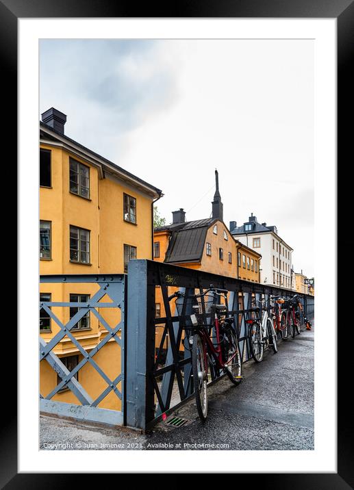 Bicycles parked in the street with colorful houses in Sodermalm  Framed Mounted Print by Juan Jimenez