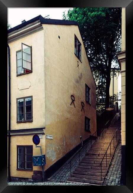 Picturesque cobblestoned street and steps with colorful houses i Framed Print by Juan Jimenez