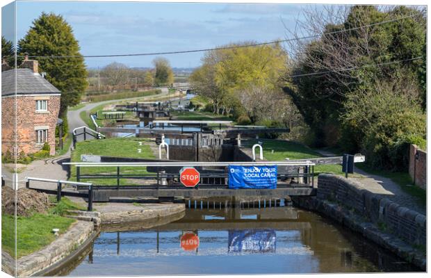 Locks reflecting in the water of Leeds Liverpool canal Canvas Print by Jason Wells