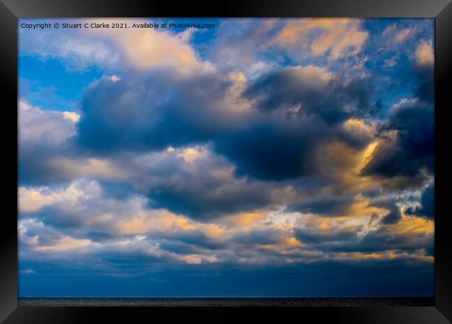 Sunset in the clouds Framed Print by Stuart C Clarke